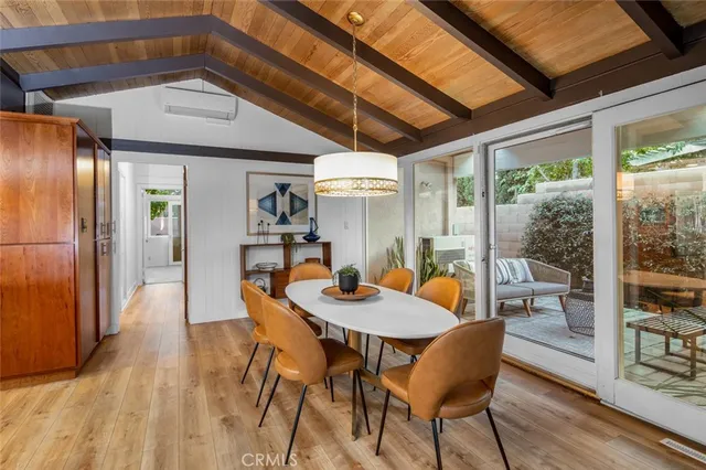 a dining room with furniture and wooden floor