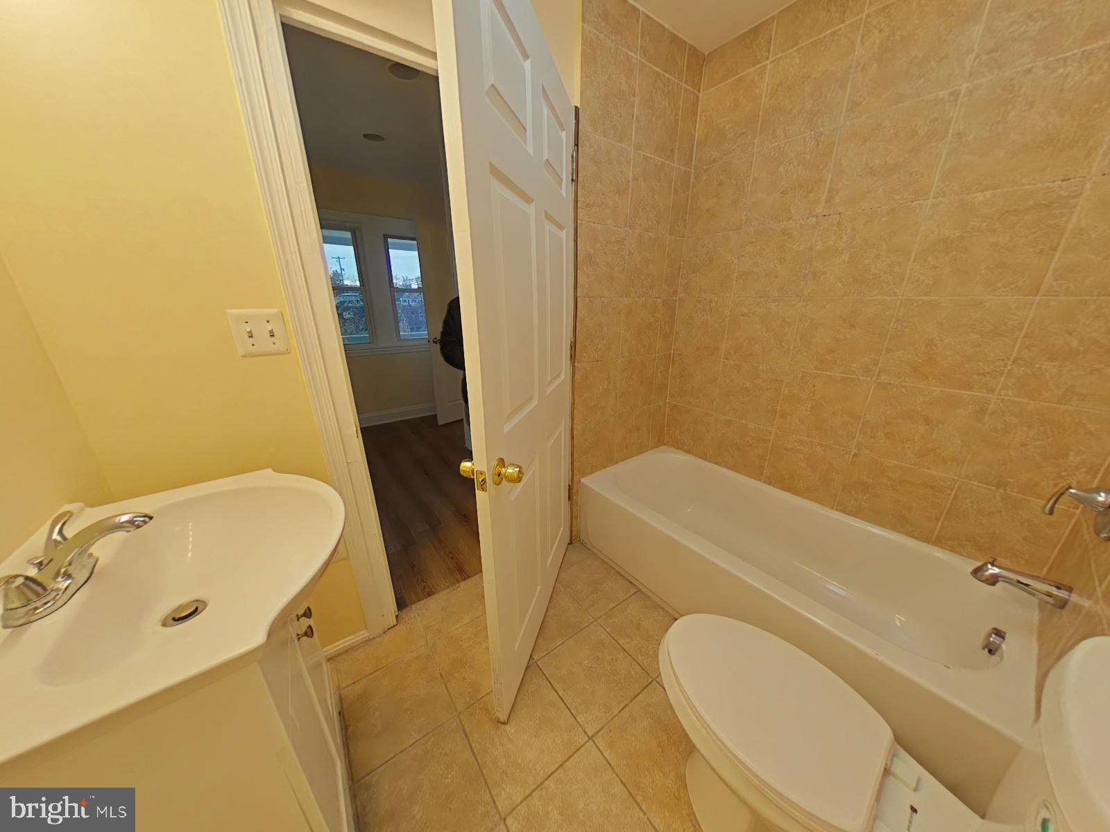 8611 Westphalia Road Upper Marlboro, MD 20772 - Photo 15 of 26 a bathroom with a tub sink and toilet