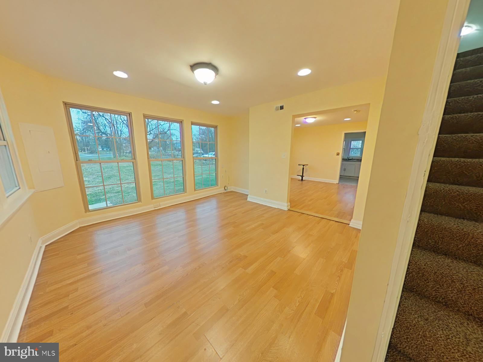 8611 Westphalia Road Upper Marlboro, MD 20772 - Photo 3 of 26 a view of an empty room with wooden floor and a window