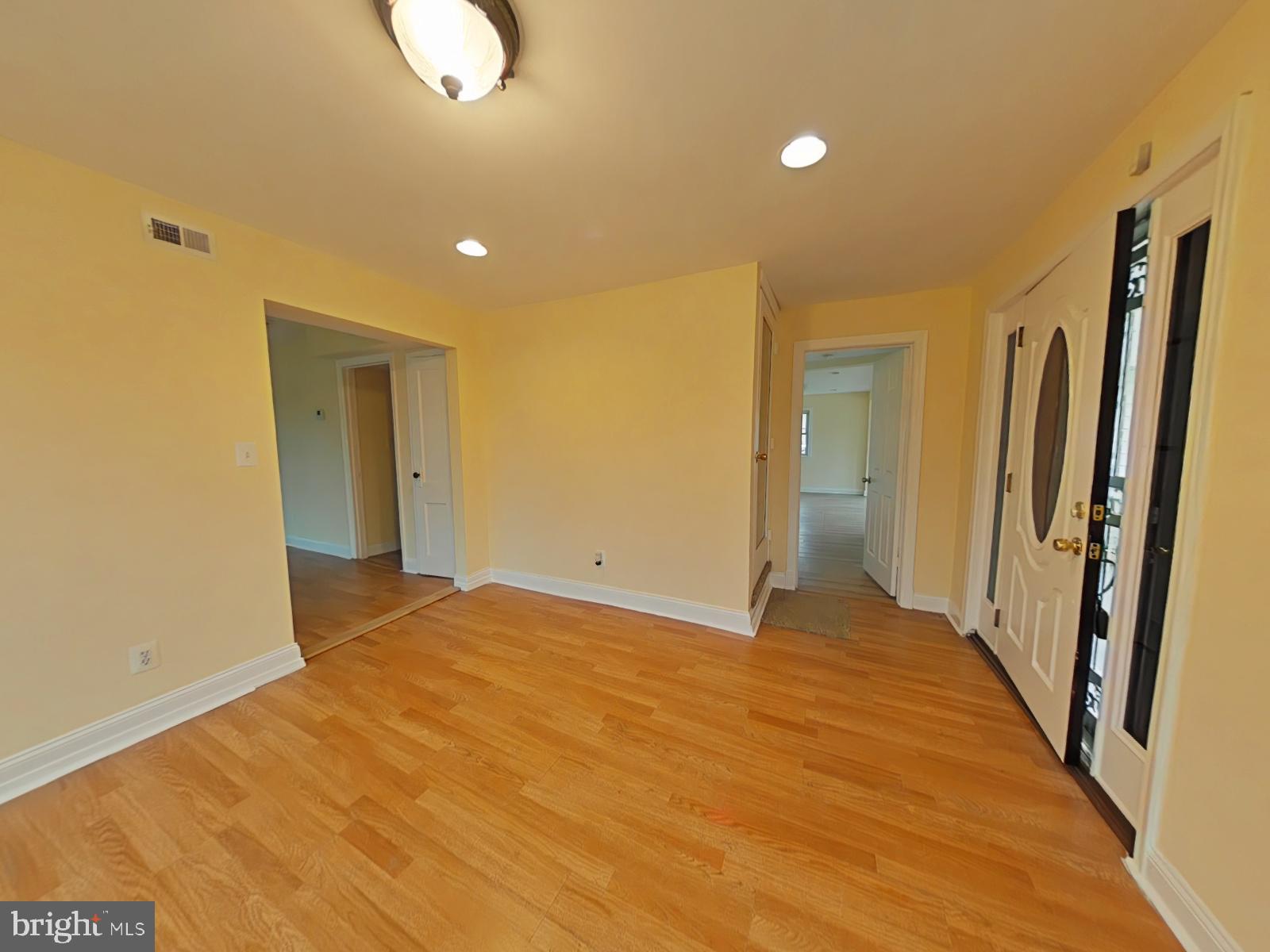8611 Westphalia Road Upper Marlboro, MD 20772 - Photo 4 of 26 a view of an empty room with wooden floor and a window
