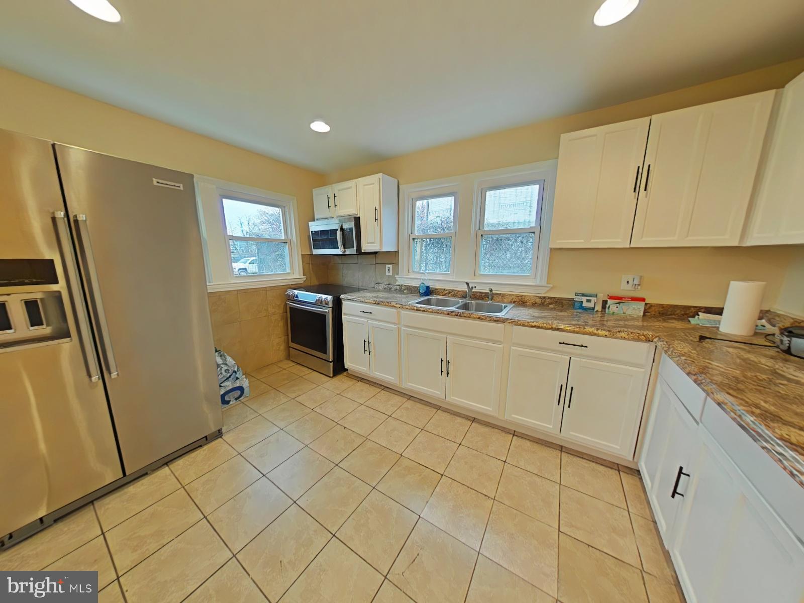8611 Westphalia Road Upper Marlboro, MD 20772 - Photo 5 of 26 a kitchen with a sink a refrigerator and cabinets