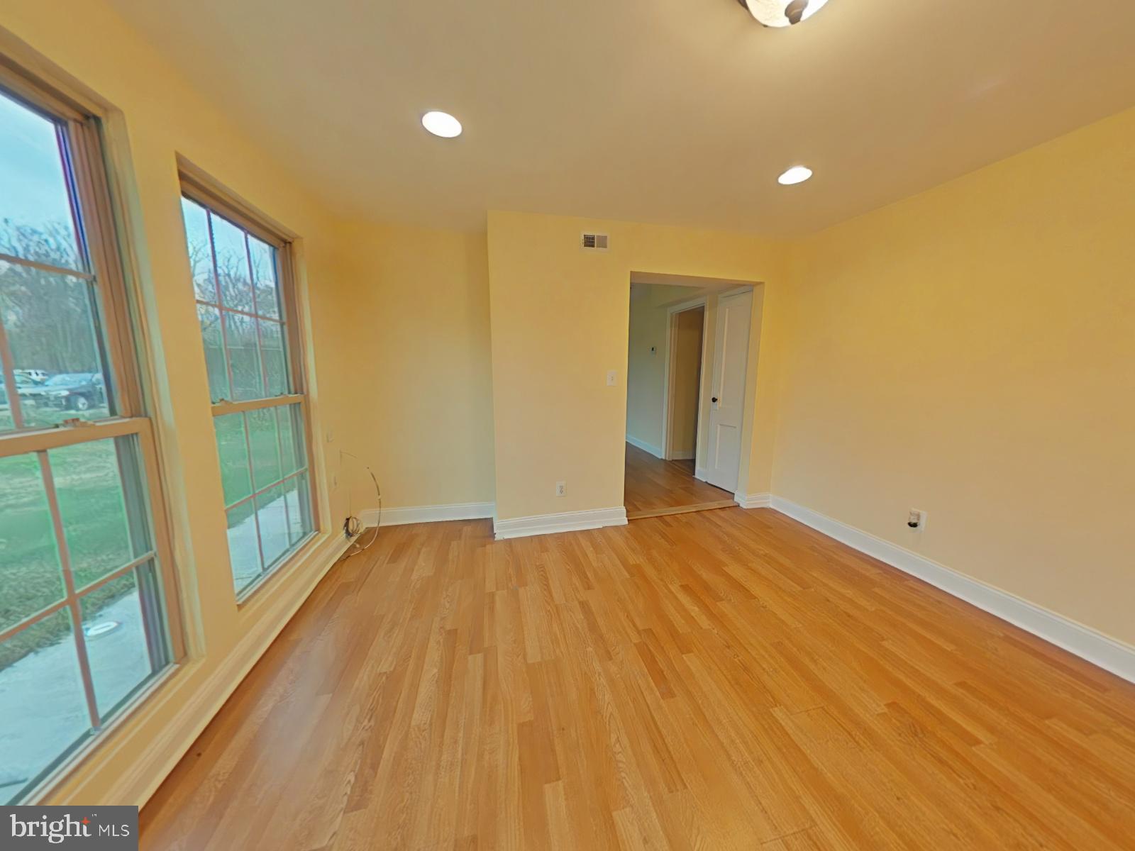 8611 Westphalia Road Upper Marlboro, MD 20772 - Photo 9 of 26 a view of empty room with wooden floor and fan