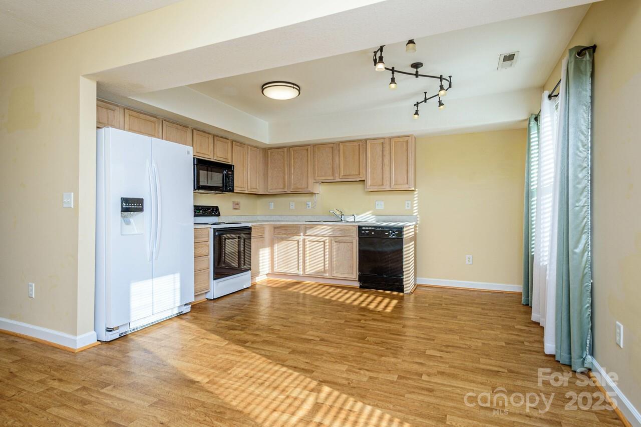 606 Olde Covington Way Arden, NC 28704 - Photo 17 of 38 a view of kitchen with granite countertop cabinets and refrigerator