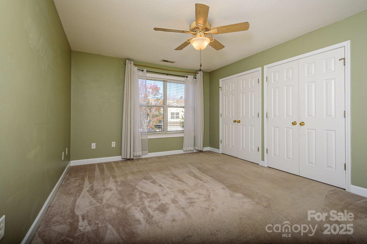 606 Olde Covington Way Arden, NC 28704 - Photo 23 of 38 an empty room with windows and fan