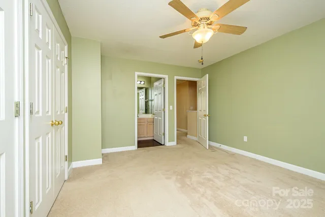 a view of a room with a windows and ceiling fan