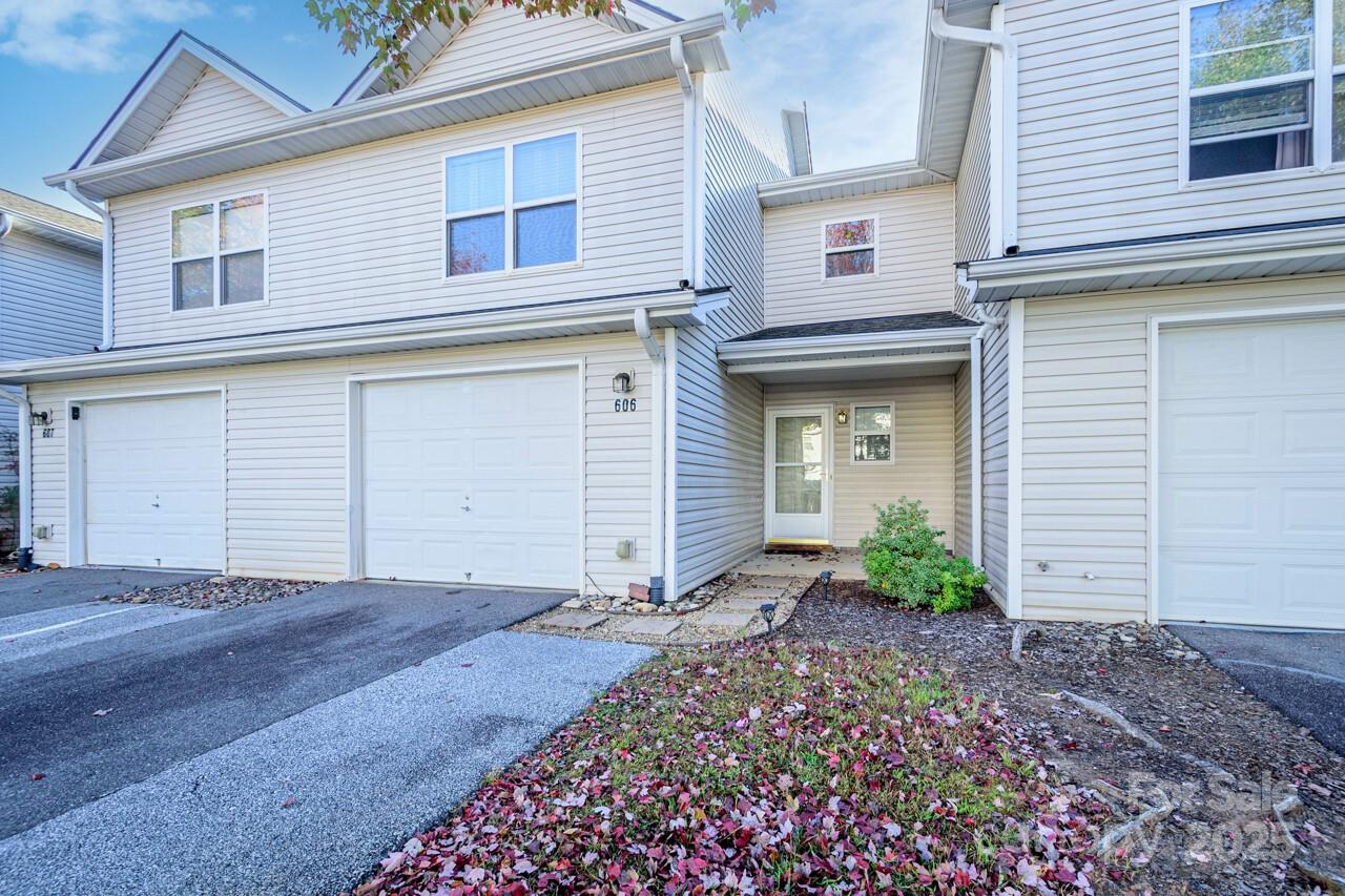 606 Olde Covington Way Arden, NC 28704 - Photo 6 of 38 a front view of a house with garden