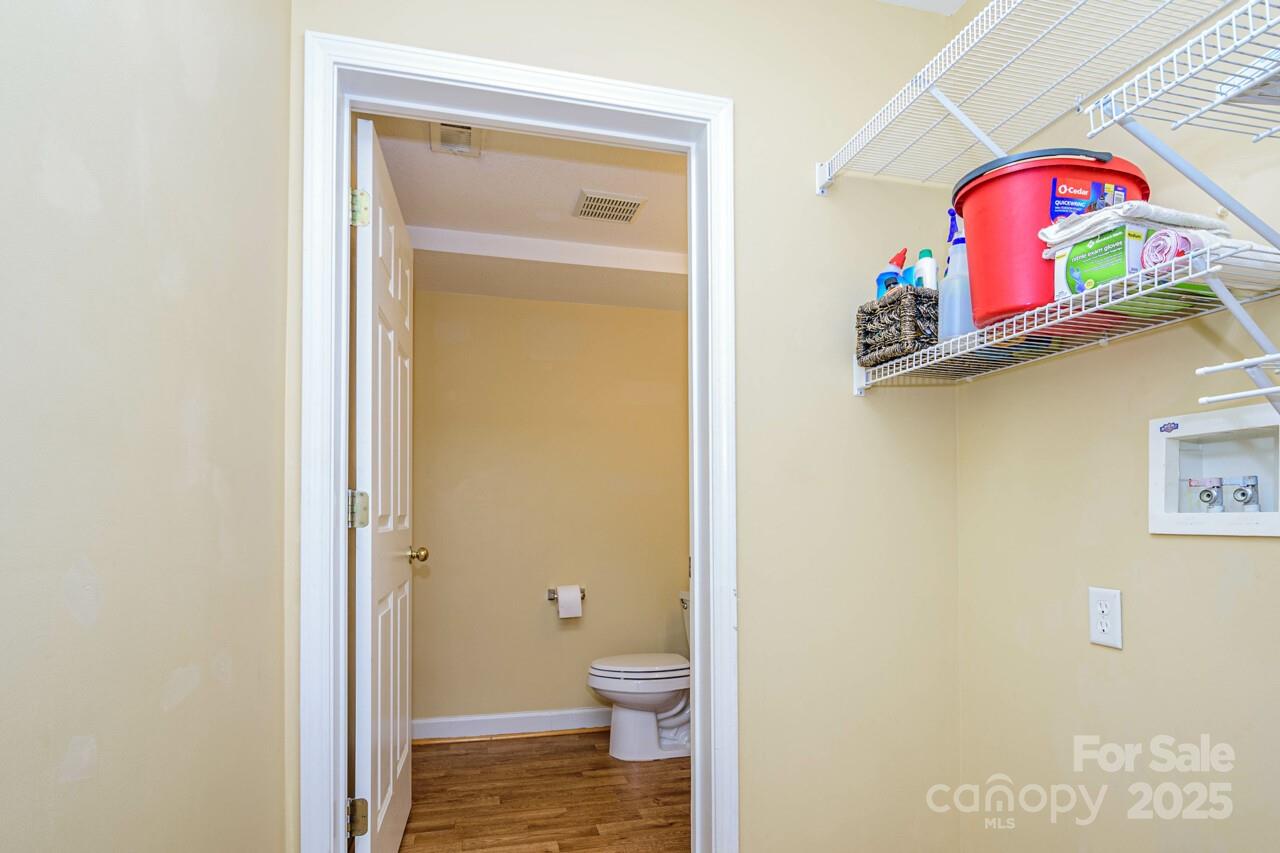 606 Olde Covington Way Arden, NC 28704 - Photo 10 of 38 a bathroom with a toilet sink and mirror