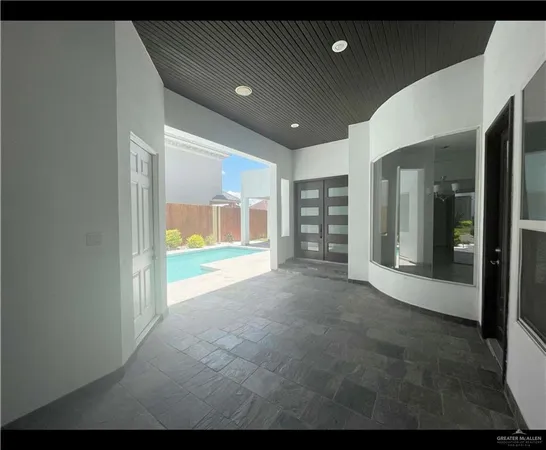 a view of an empty room with glass door
