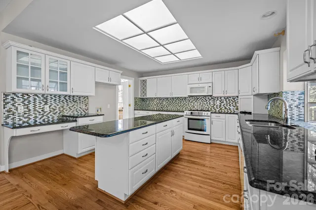 a view of an empty room with window and fire place