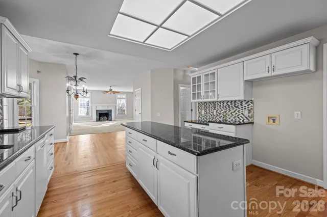 a view of empty room with fireplace and fan