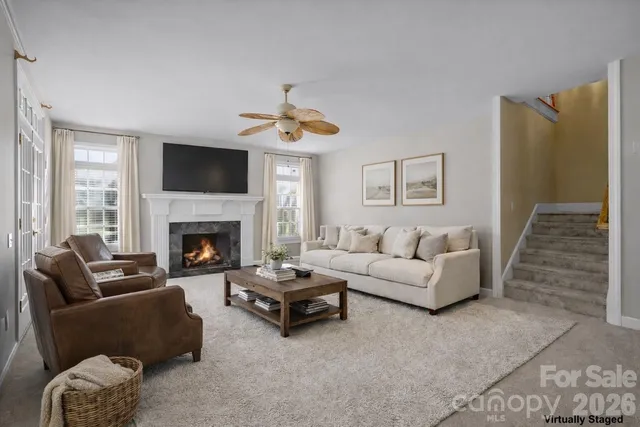 a swimming pool with outdoor seating and trees