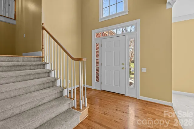 a view of a hallway with wooden floor and entryway