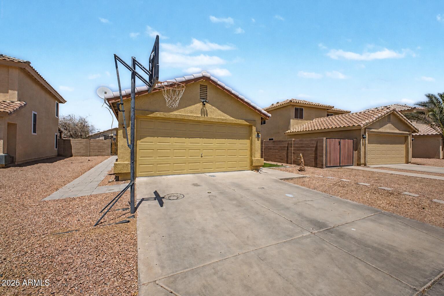 12008 West Larkspur Road El Mirage, AZ 85335 - Photo 24 of 25 a front view of a house with a yard and garage