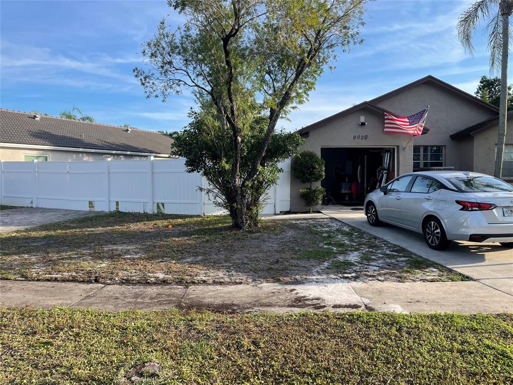 9020 Pine Springs Drive Boca Raton, FL 33428 - Photo 15 of 21 a house view with a car parked in front of a house
