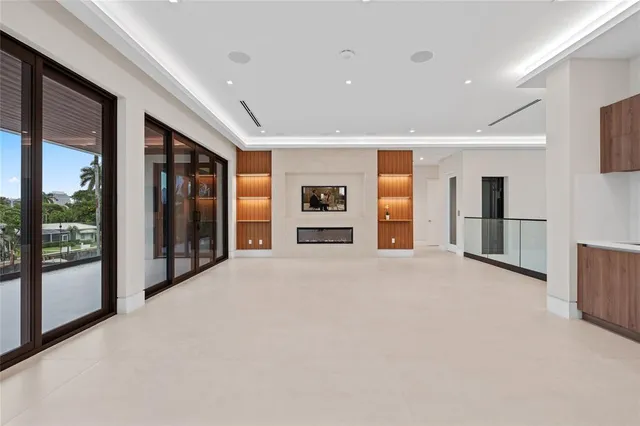 a living room with furniture and large windows