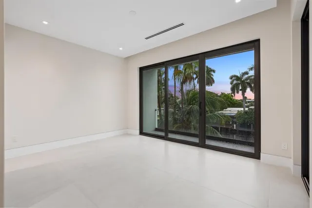 a living room with furniture and view of kitchen