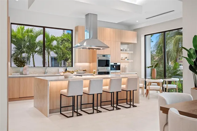a large white kitchen with a large window