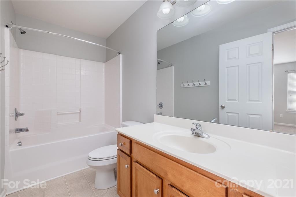 17107 Hampton Trace Road Huntersville, NC 28078 - Photo 16 of 18 a bathroom with a bathtub shower sink vanity mirror and toilet