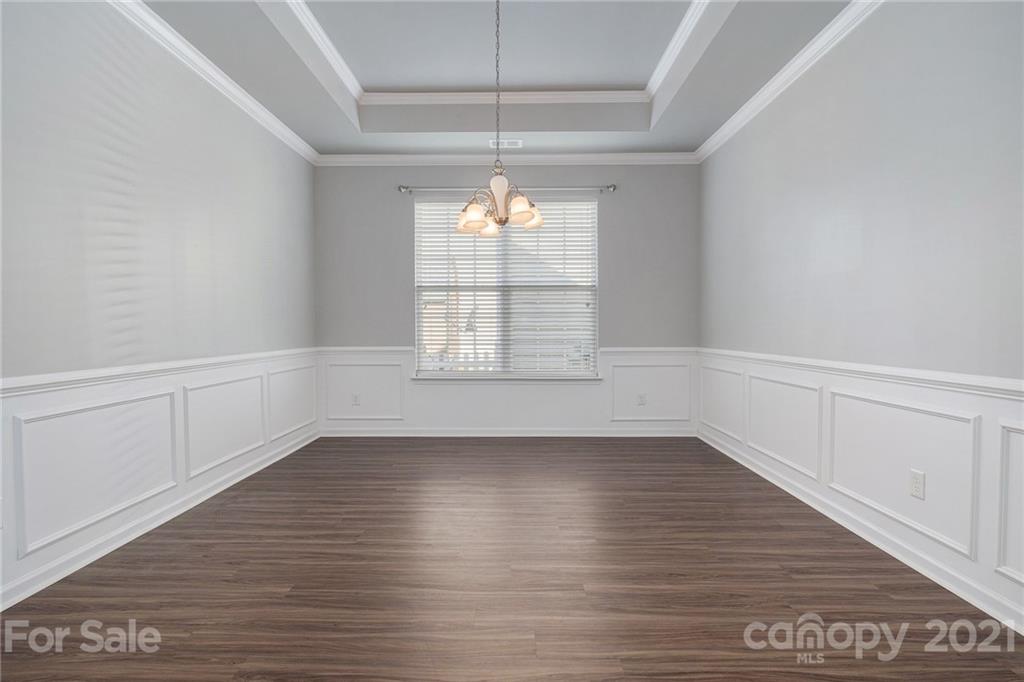 17107 Hampton Trace Road Huntersville, NC 28078 - Photo 9 of 18 an empty room with wooden floor and windows