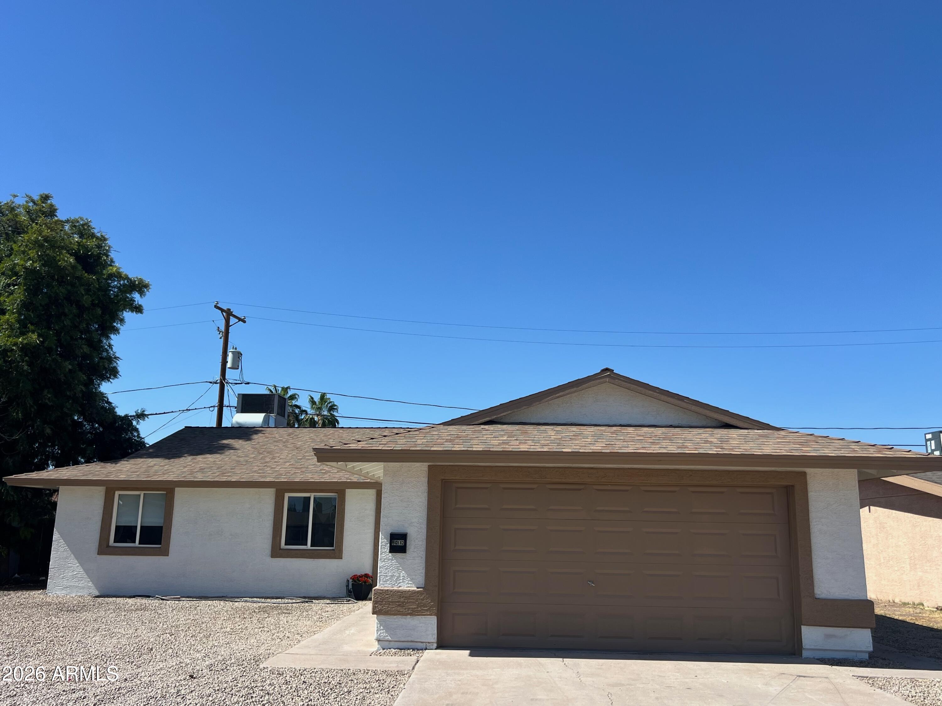 3818 West Ruth Avenue Phoenix, AZ 85051 - Photo 1 of 20 a front view of a house with a yard