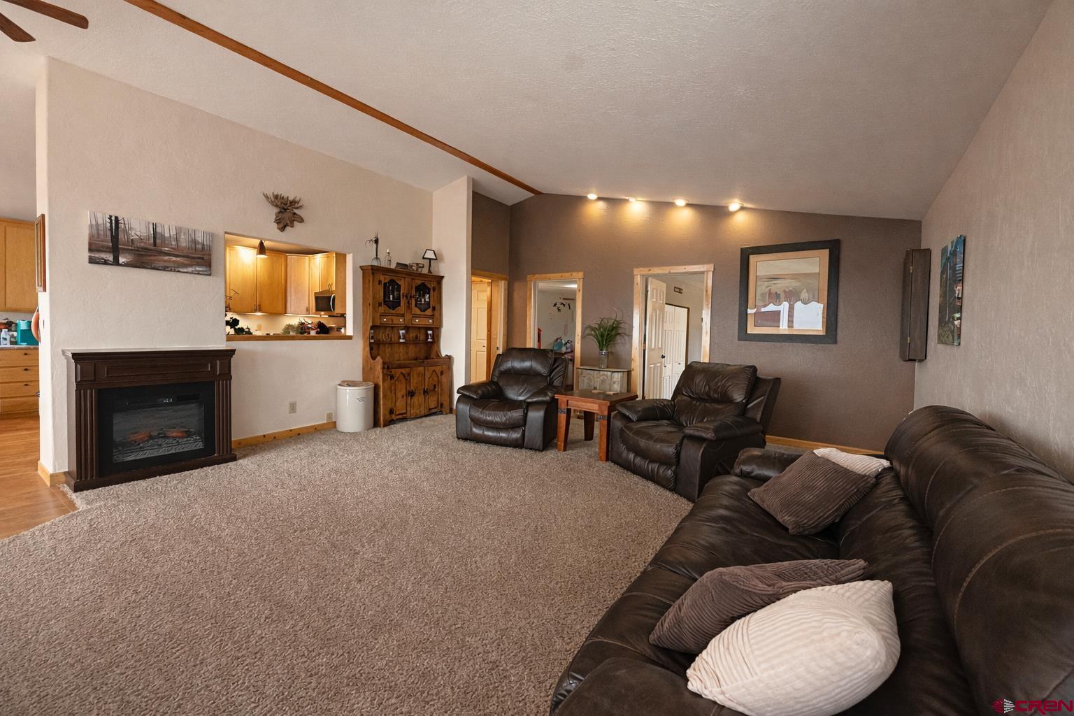 21976 2225th Road Cedaredge, CO 81413 - Photo 12 of 36 a living room with furniture and a fireplace