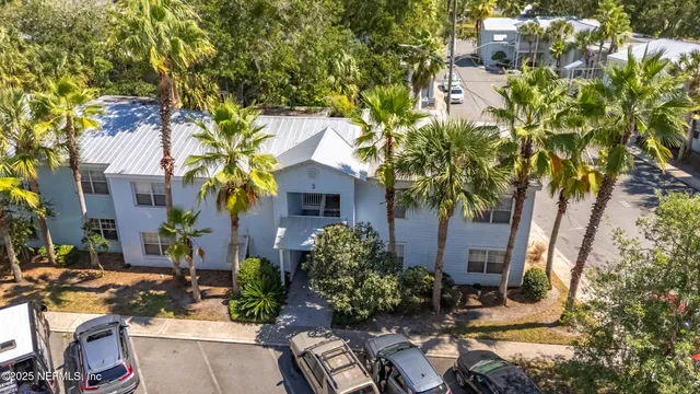 a view of backyard with outdoor seating and trees