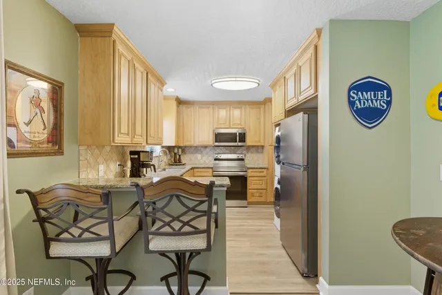 a view of a kitchen with dining table and chairs