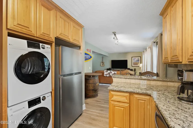 a kitchen with stainless steel appliances granite countertop a sink a stove and refrigerator