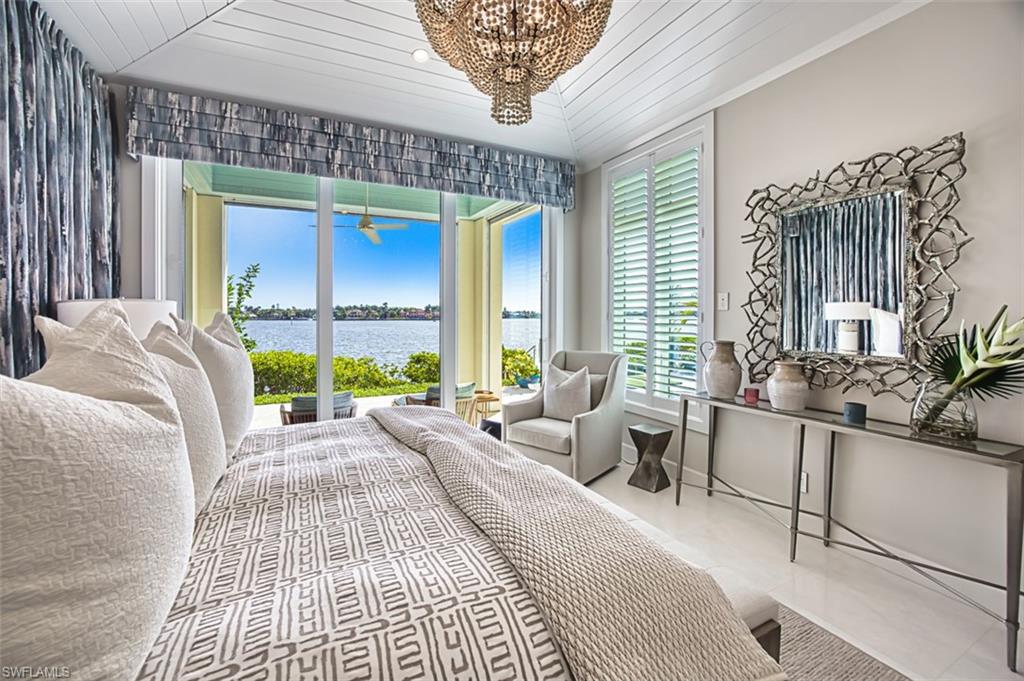 1340 Jewel Naples, FL 34102 - Photo 10 of 44 Tiled bedroom with a water view, a chandelier, and wooden ceiling