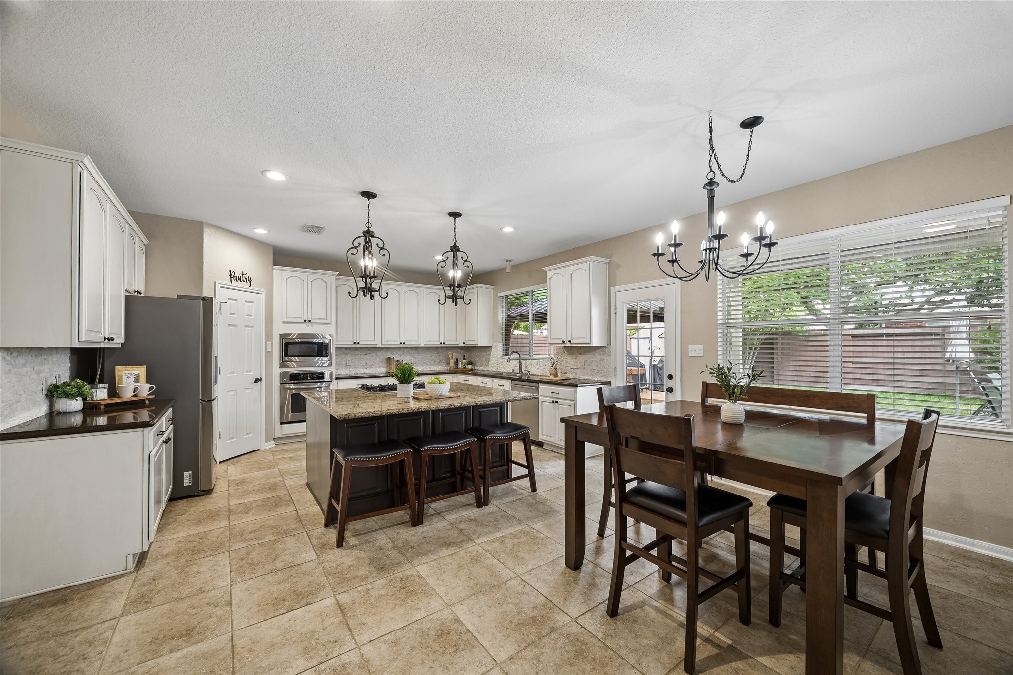 9122 Memorial Valley Drive Spring, TX 77379 - Photo 10 of 35 a large kitchen with a table and chairs