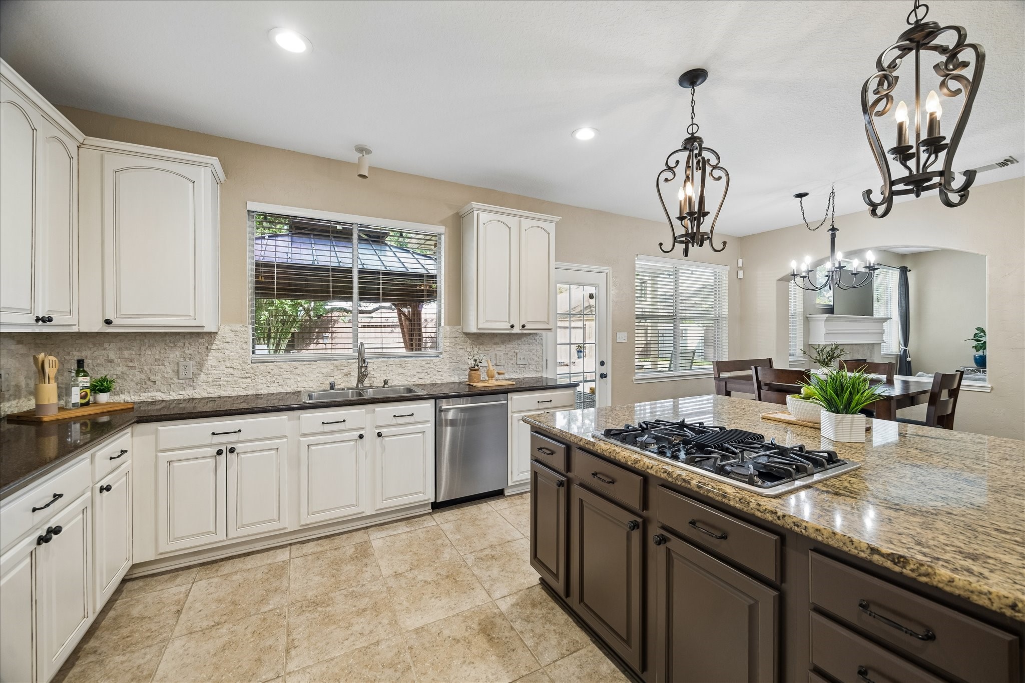 9122 Memorial Valley Drive Spring, TX 77379 - Photo 12 of 35 a kitchen with stainless steel appliances granite countertop a sink a stove and cabinets