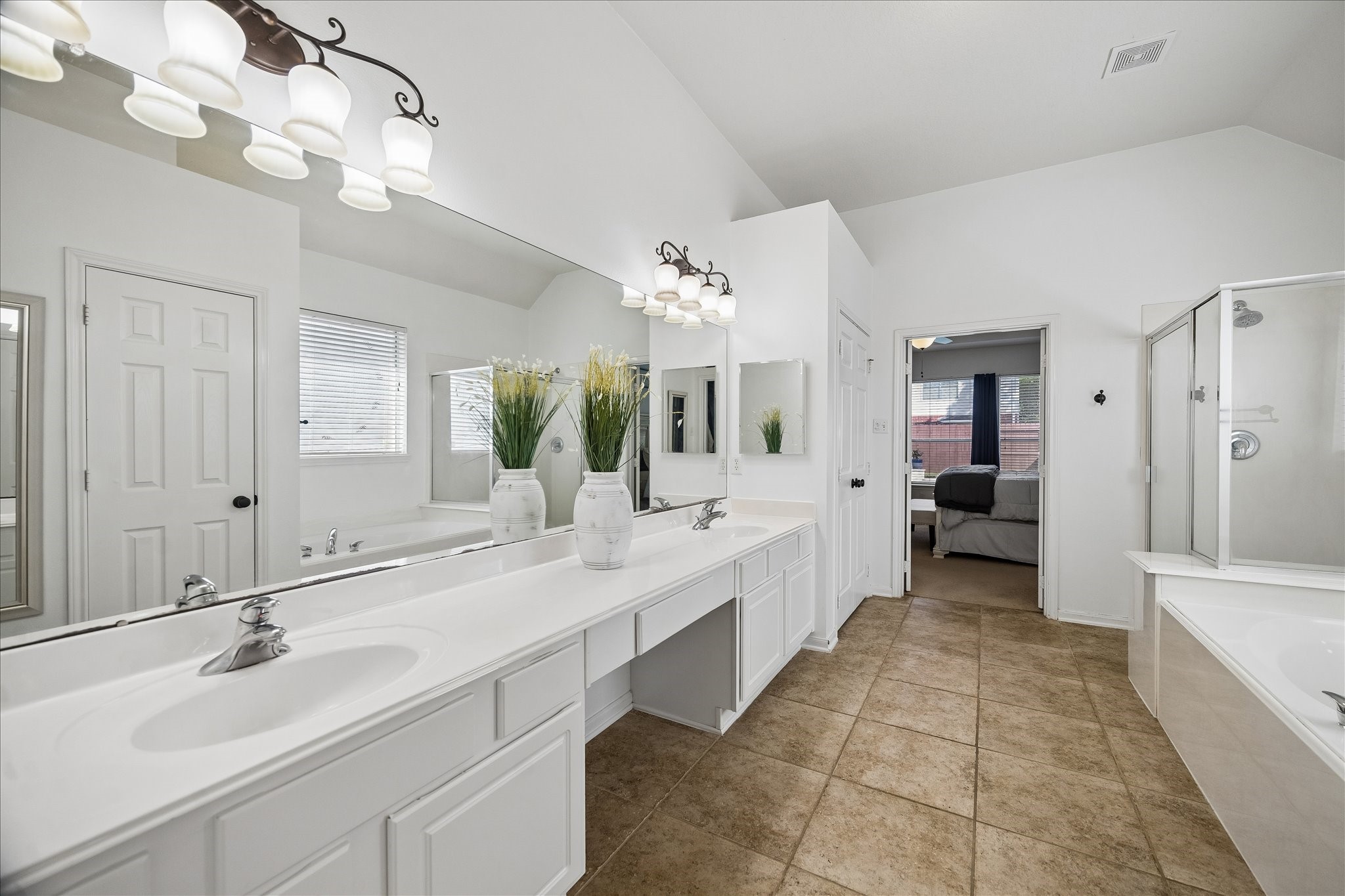 9122 Memorial Valley Drive Spring, TX 77379 - Photo 18 of 35 a large bathroom with a sink a large mirror and vanity