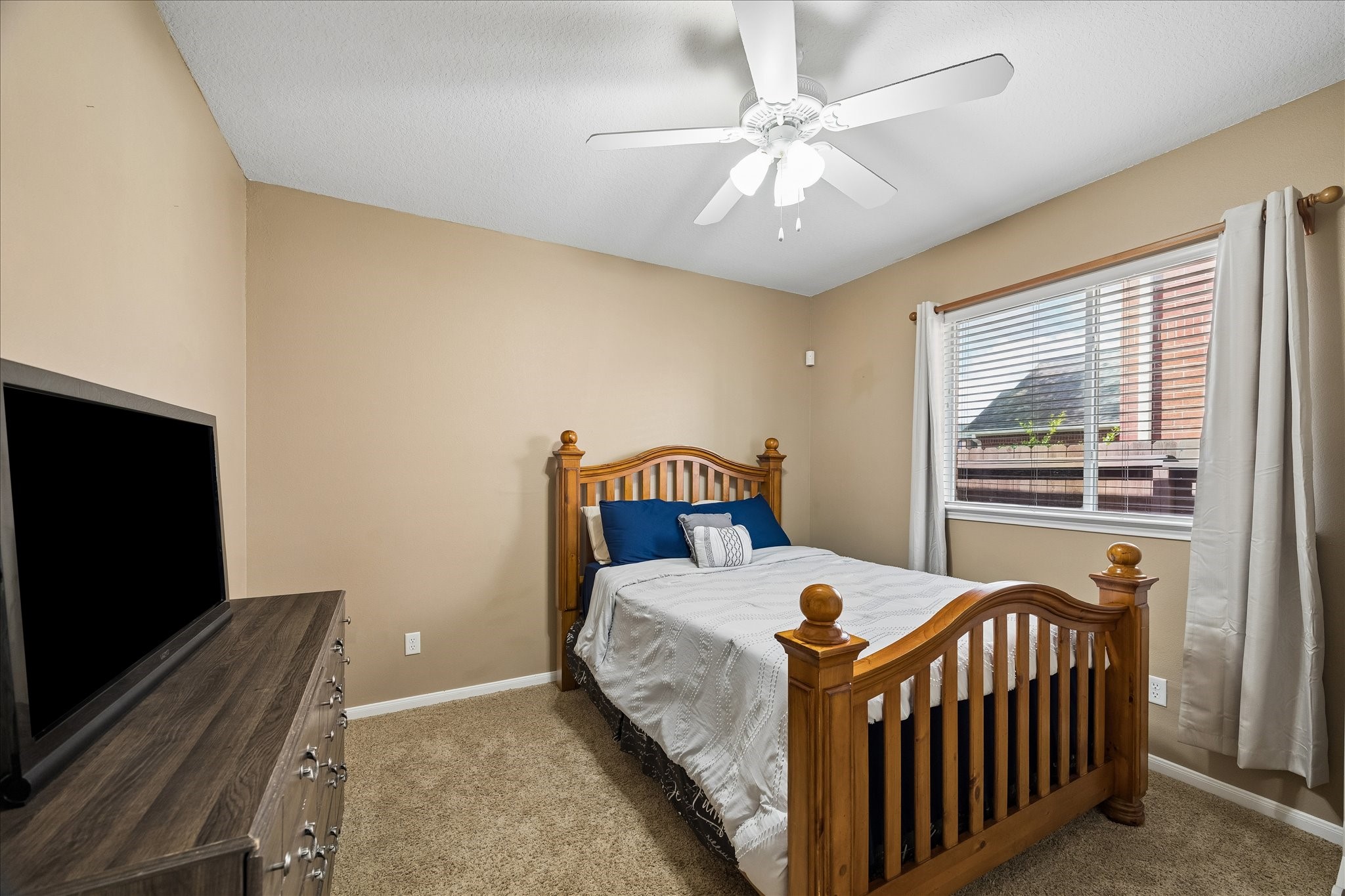 9122 Memorial Valley Drive Spring, TX 77379 - Photo 19 of 35 a bed sitting in a bedroom next to a window