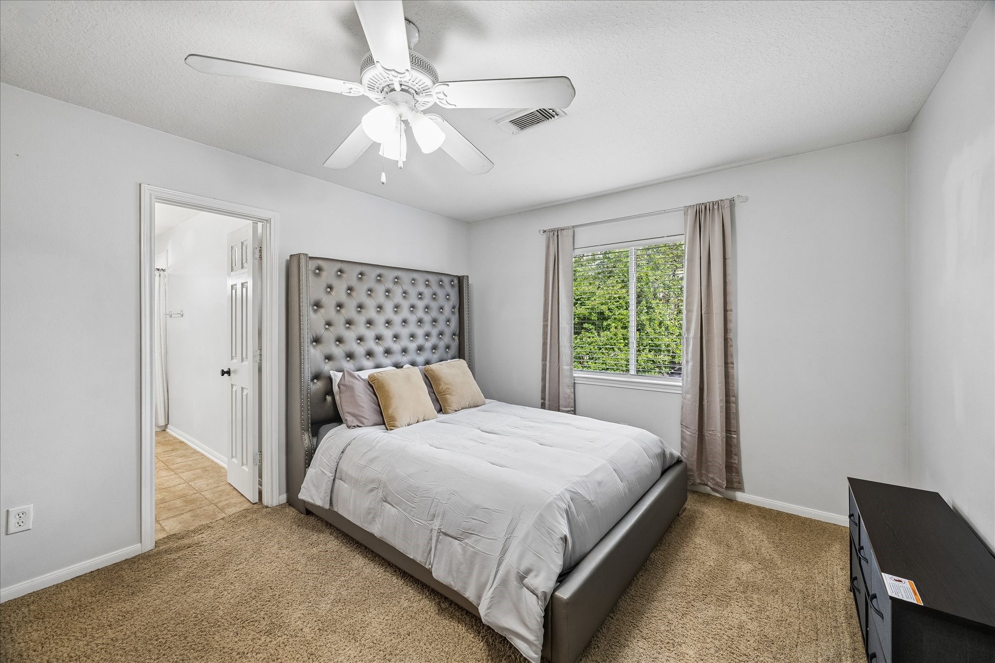 9122 Memorial Valley Drive Spring, TX 77379 - Photo 23 of 35 a bedroom with a large bed and a window