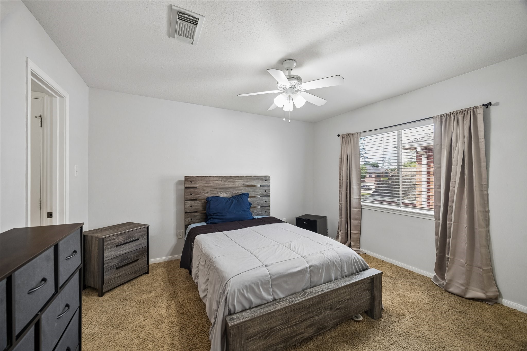 9122 Memorial Valley Drive Spring, TX 77379 - Photo 26 of 35 a bedroom with a bed and a tv