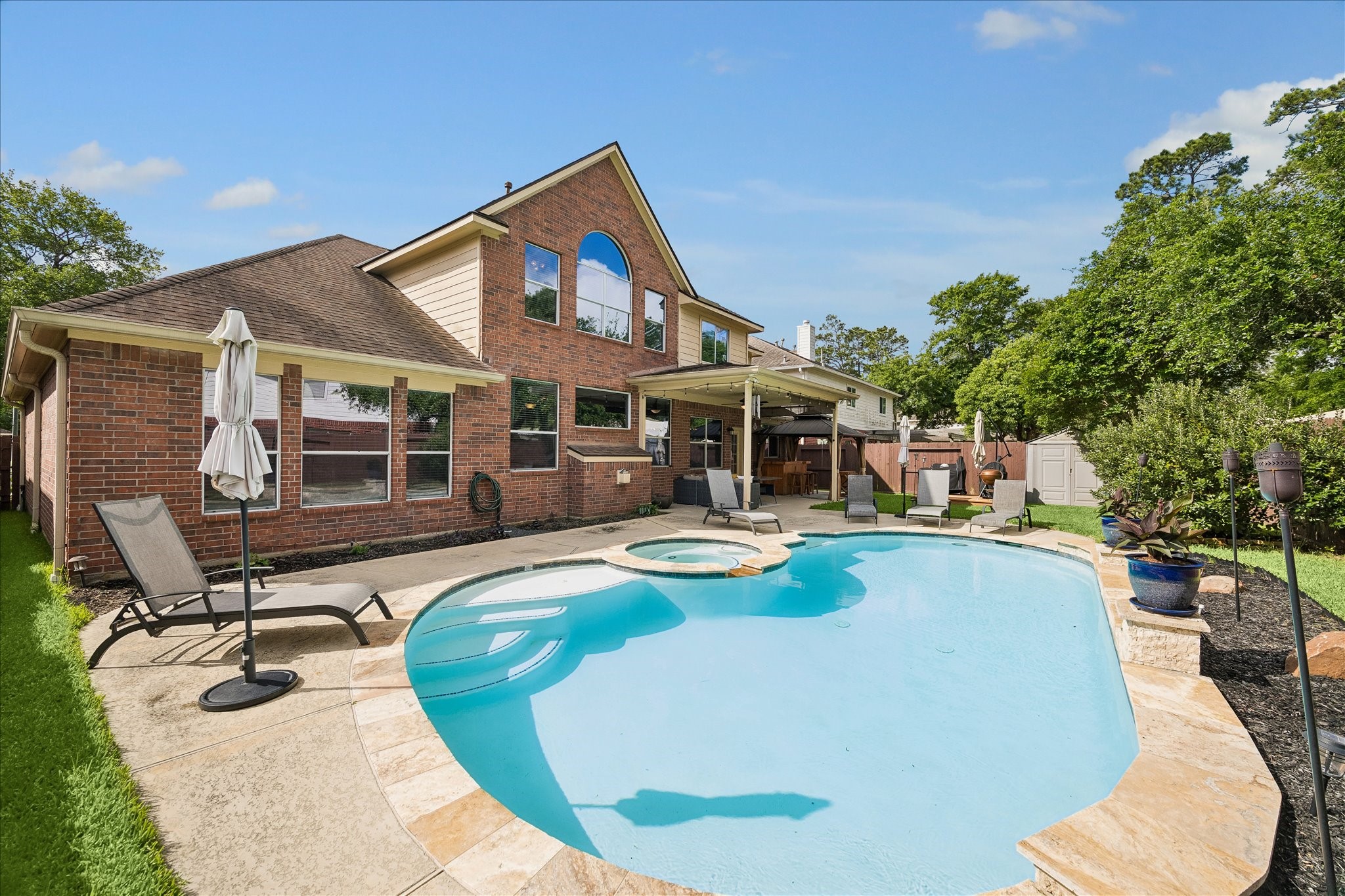 9122 Memorial Valley Drive Spring, TX 77379 - Photo 28 of 35 a view of a house with swimming pool and sitting area
