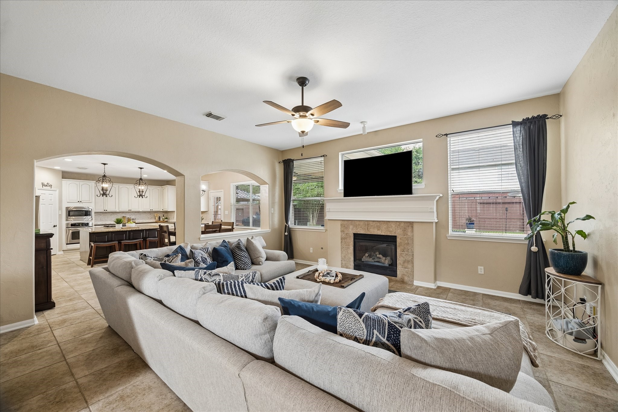 9122 Memorial Valley Drive Spring, TX 77379 - Photo 8 of 35 a living room with furniture fireplace and a flat screen tv