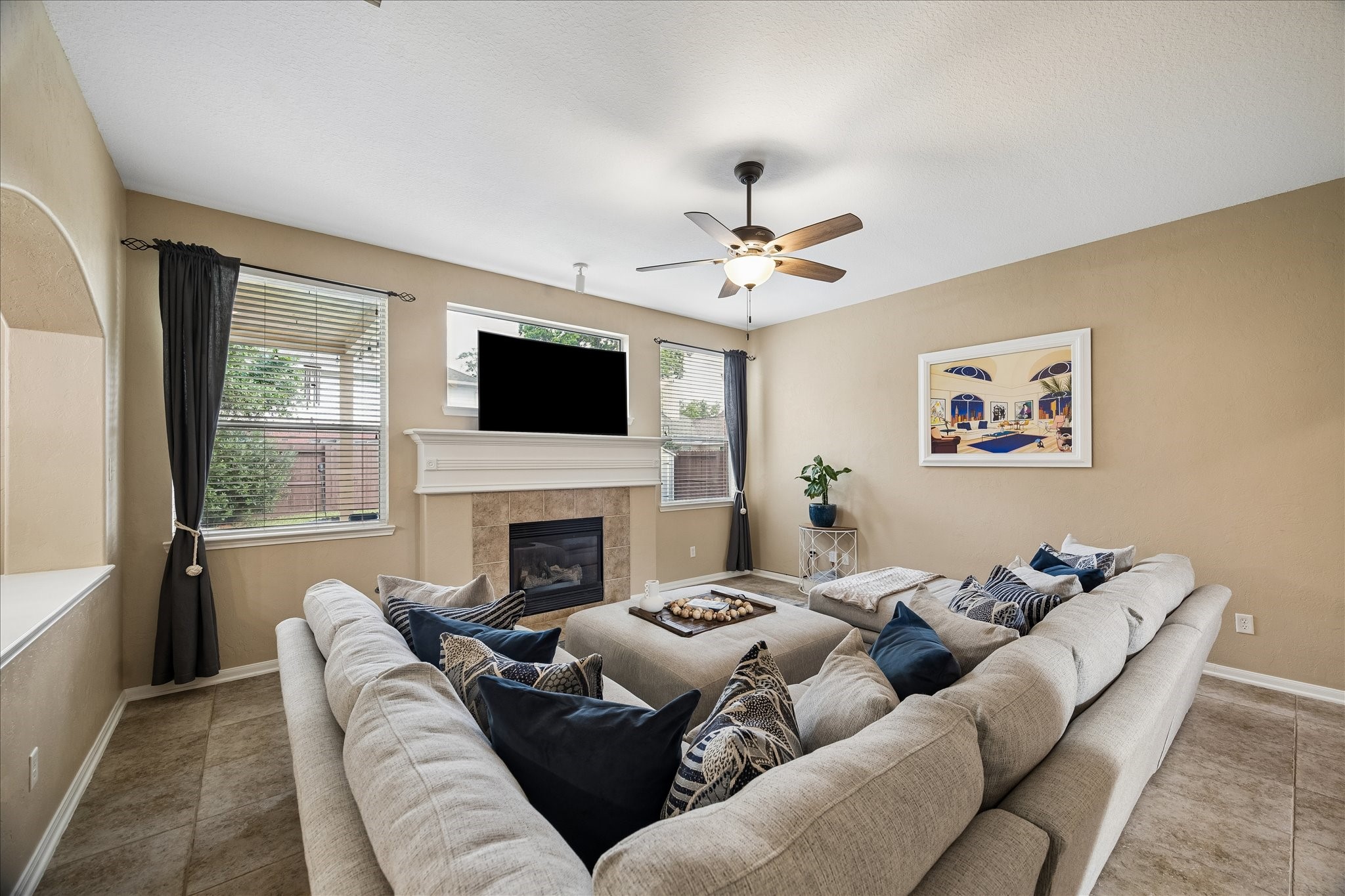9122 Memorial Valley Drive Spring, TX 77379 - Photo 9 of 35 a living room with furniture a fireplace and a flat screen tv