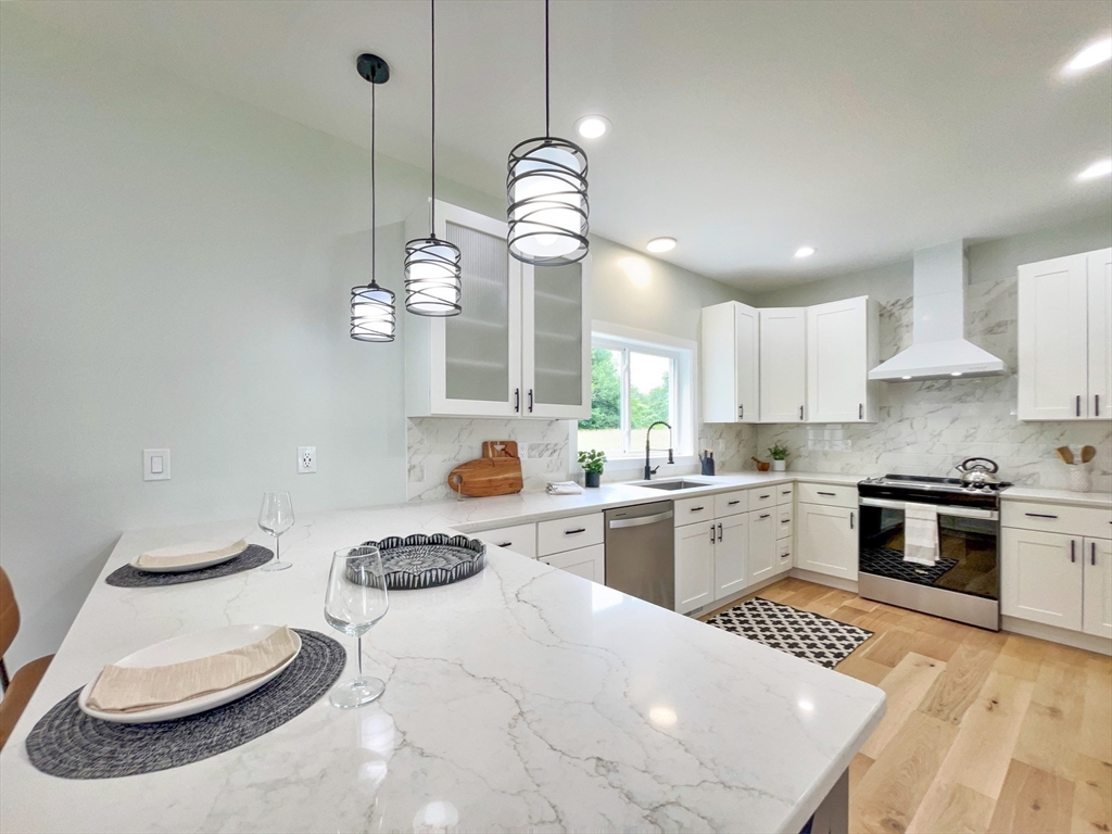 101 N Road Westfield, MA 01085 - Photo 11 of 40 a kitchen with stainless steel appliances granite countertop a sink a stove and a wooden floors