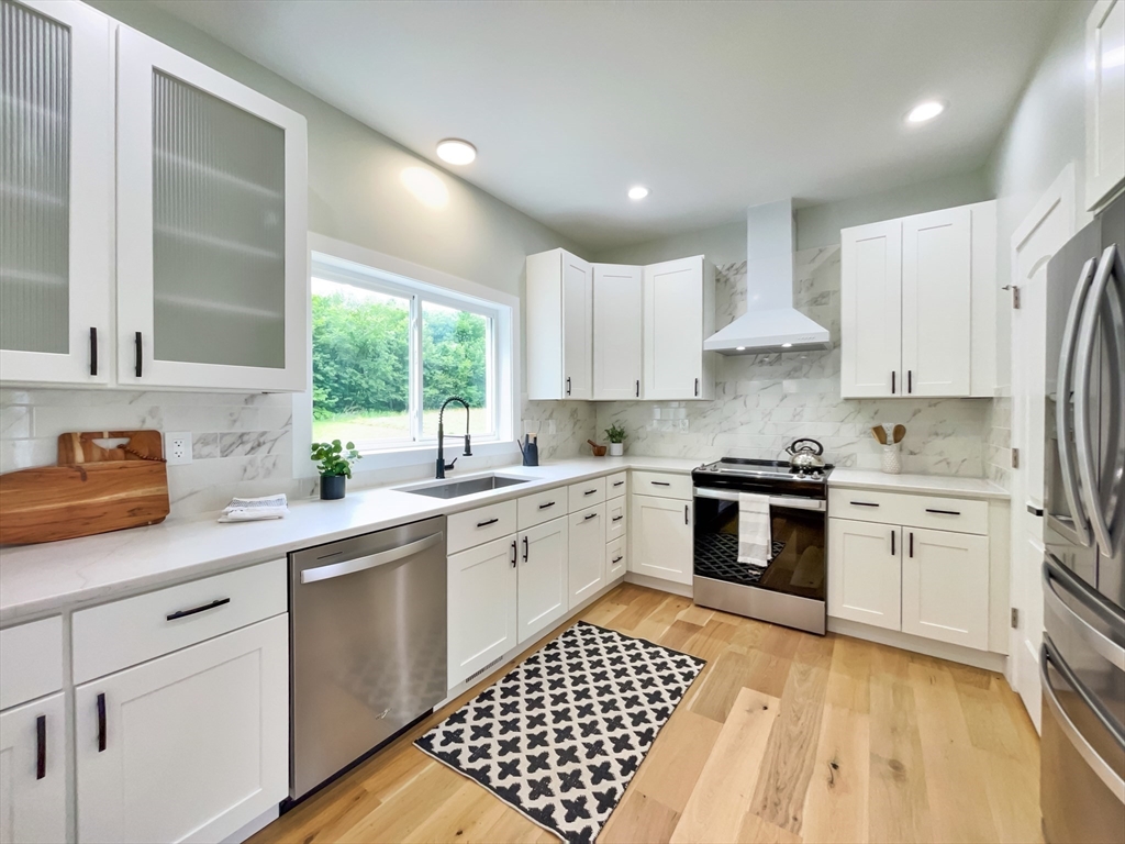 101 N Road Westfield, MA 01085 - Photo 12 of 40 a kitchen with a white stove top oven sink and cabinets