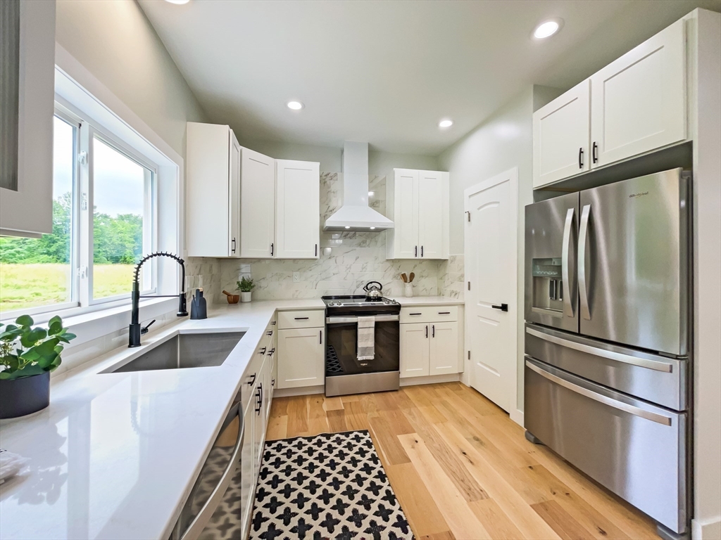 101 N Road Westfield, MA 01085 - Photo 13 of 40 a kitchen with granite countertop a refrigerator stove and sink