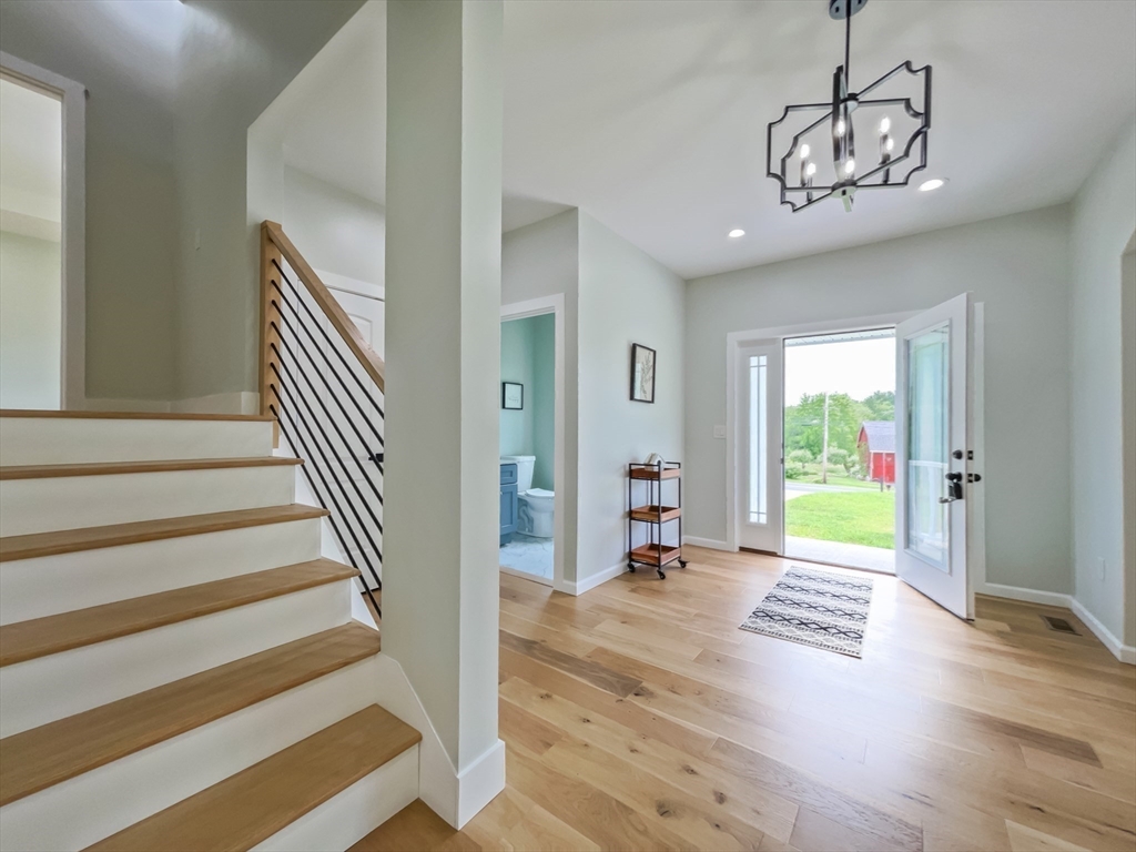 101 N Road Westfield, MA 01085 - Photo 20 of 40 a view of an empty room with wooden floor and a chandelier