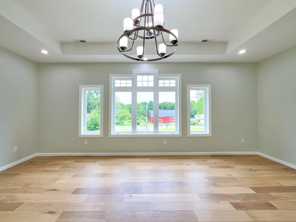 101 N Road Westfield, MA 01085 - Photo 25 of 40 an empty room with wooden floor and windows