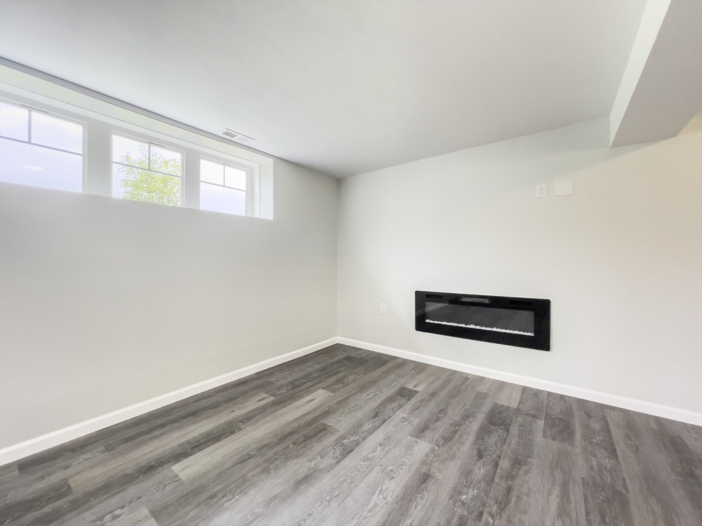 101 N Road Westfield, MA 01085 - Photo 35 of 40 an empty room with wooden floor and windows