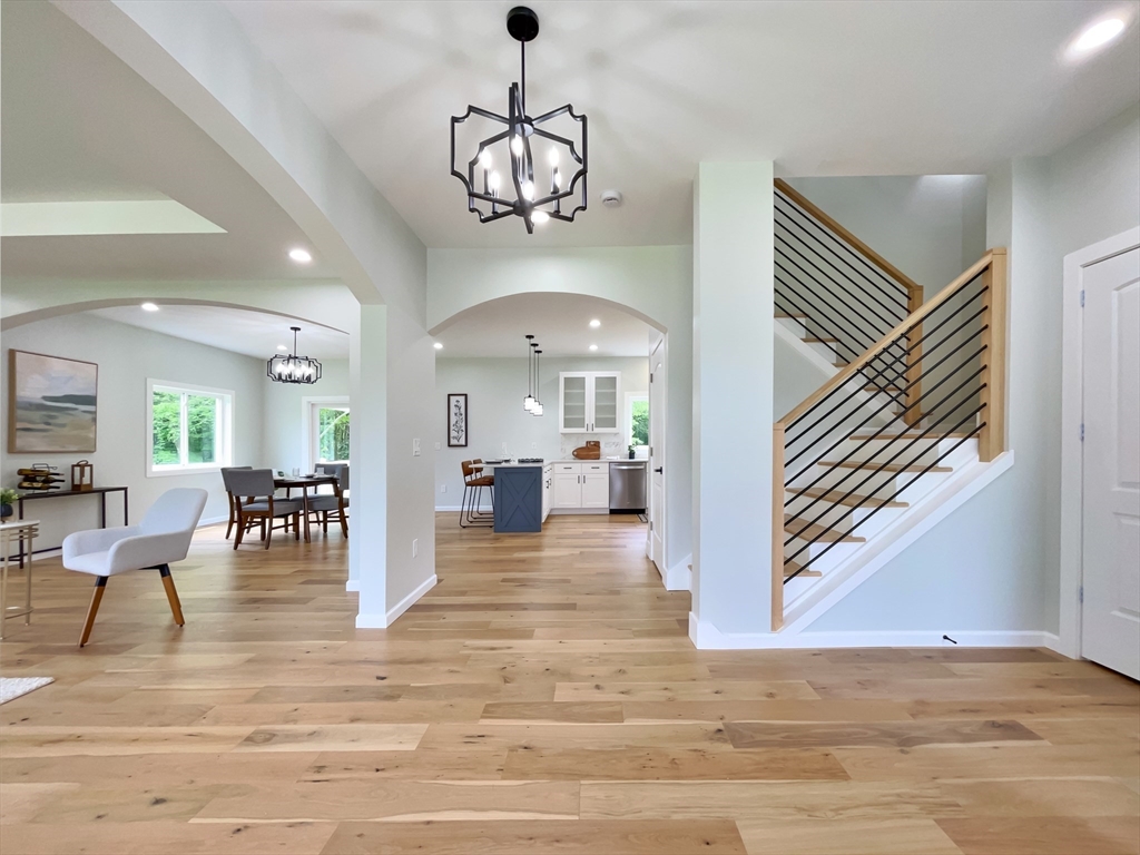101 N Road Westfield, MA 01085 - Photo 6 of 40 a view of a dining room and livingroom with furniture wooden floor a chandelier