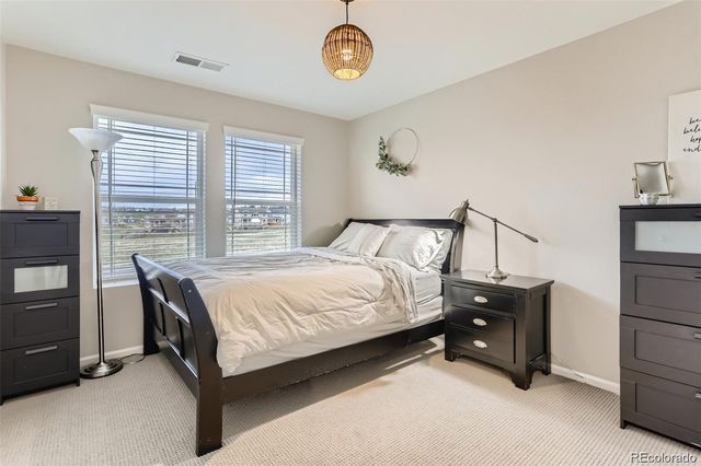 a bedroom with a bed window and a table