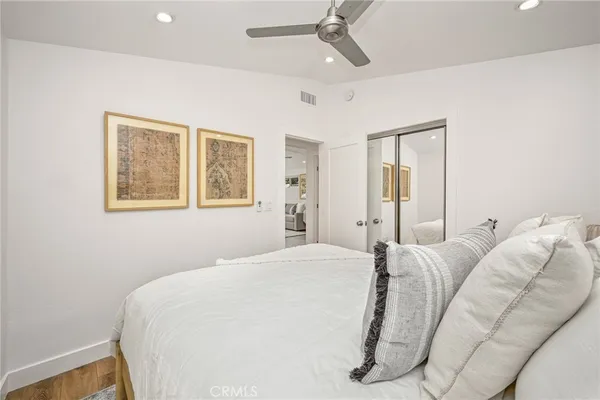 a bedroom with a bed and a painting on the wall