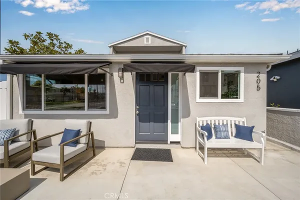 a view of a porch with furniture and floor to ceiling window
