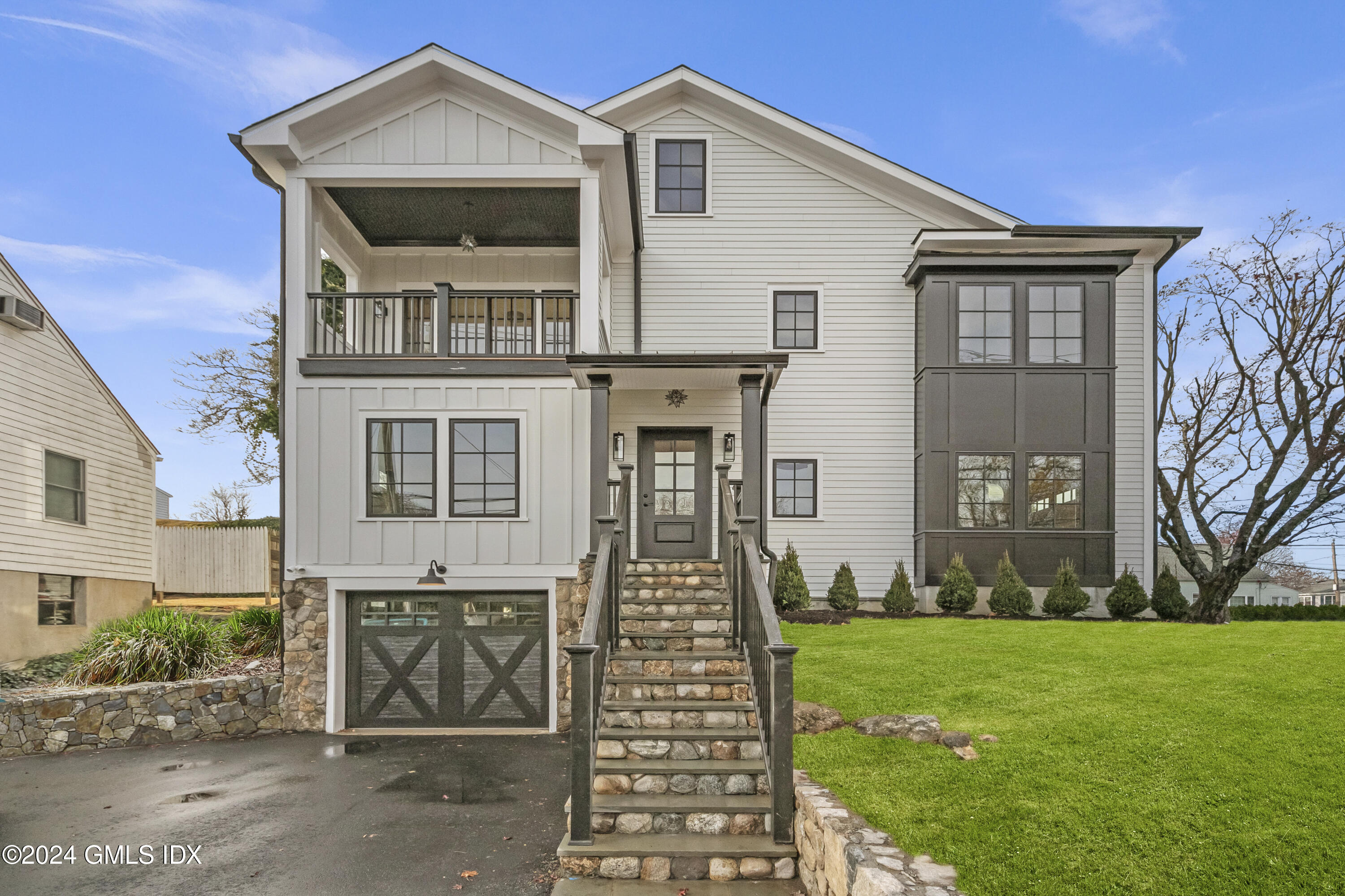 96 Weaver Street, Unit A Greenwich, CT 06831 - Photo 1 of 26 a front view of a house with garden