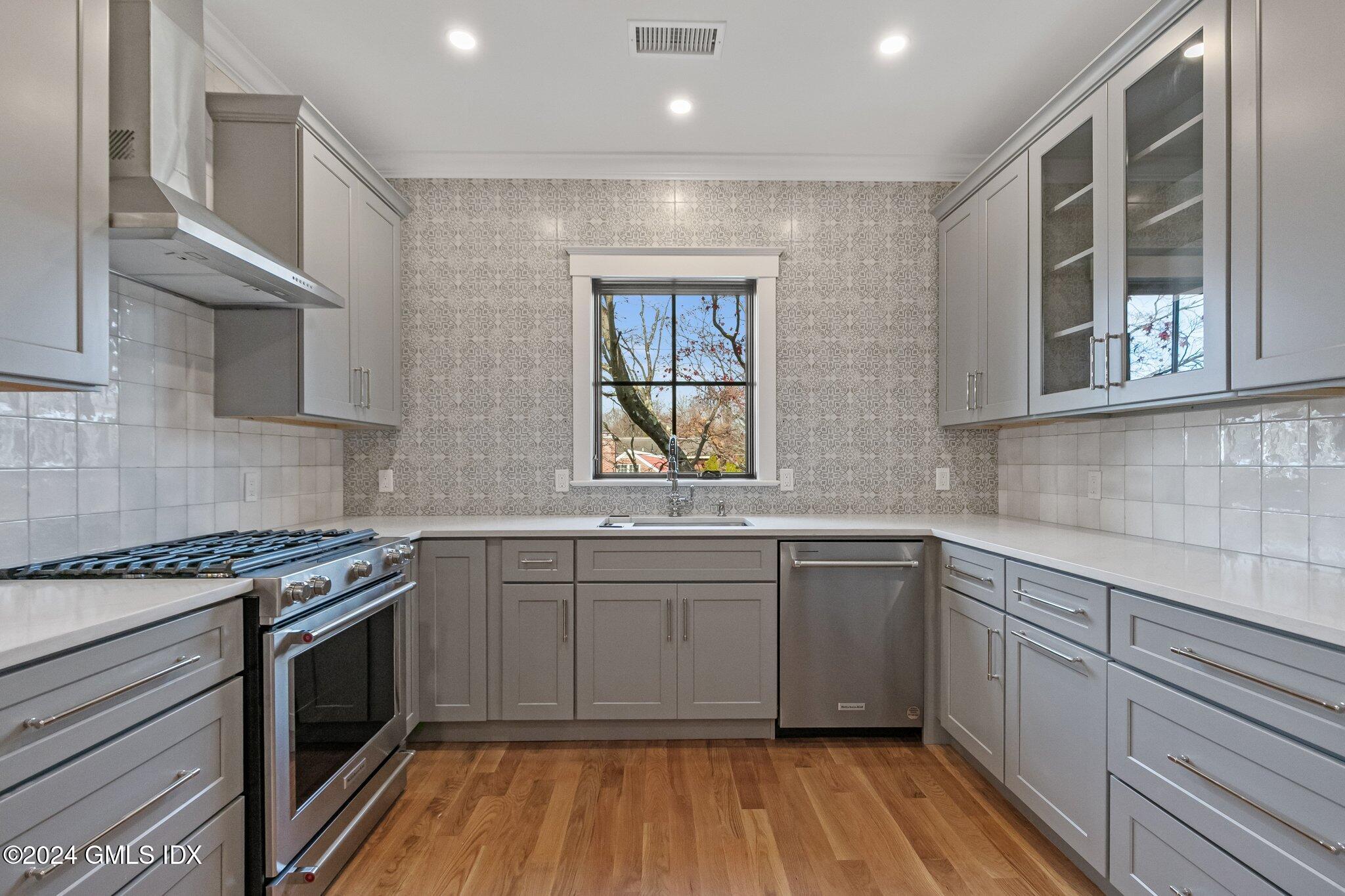 96 Weaver Street, Unit A Greenwich, CT 06831 - Photo 11 of 26 a kitchen with stainless steel appliances granite countertop hardwood a stove sink and cabinets